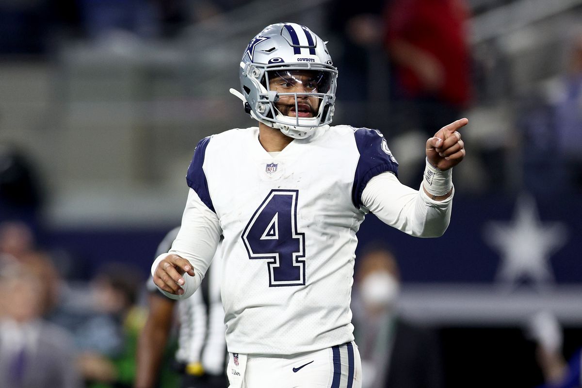 Dak Prescott #4 of the Dallas Cowboys reacts after completing a pass against the Arizona Cardinals in the fourth quarter at AT&amp;T Stadium on January 02, 2022 in Arlington, Texas.