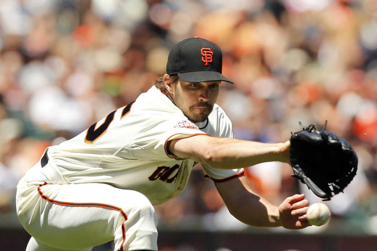 Barry Zito fields a relay throw after replacing Brandon Belt at 1st base.