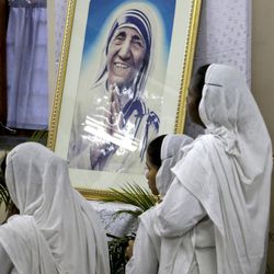 Nuns of Missionaries of Charity, the order founded by Mother Teresa, portrait seen, join in a special mass in relation to her canonization, beside her tomb in Kolkata, India, Tuesday, March 15, 2016 Mother Teresa will be made a saint on Sept. 4. Pope Francis set the canonization date Tuesday, paving the way for the nun who cared for the poorest of the poor to become the centerpiece of his yearlong focus on the Catholic Church's merciful side. 