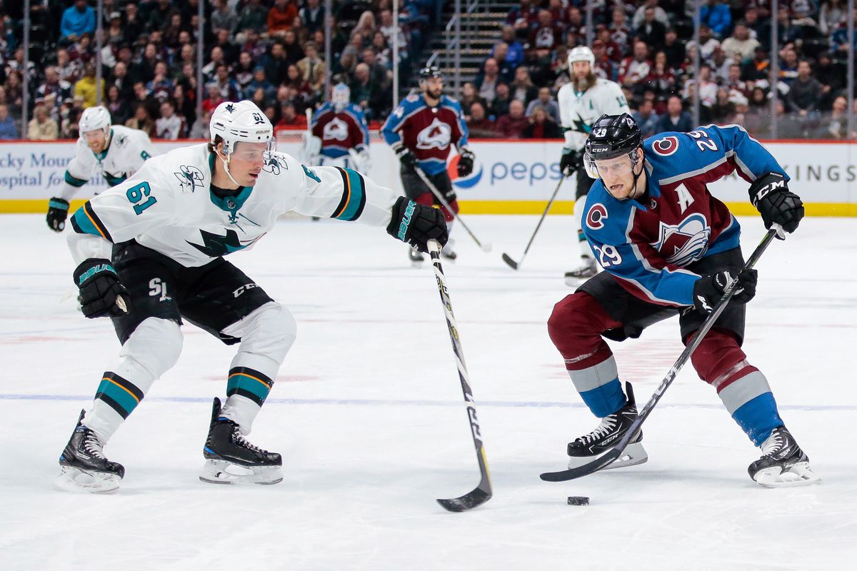 Jan 18, 2018; Denver, CO, USA; San Jose Sharks defenseman Justin Braun (61) defends against Colorado Avalanche center Nathan MacKinnon (29) in the second period at the Pepsi Center.