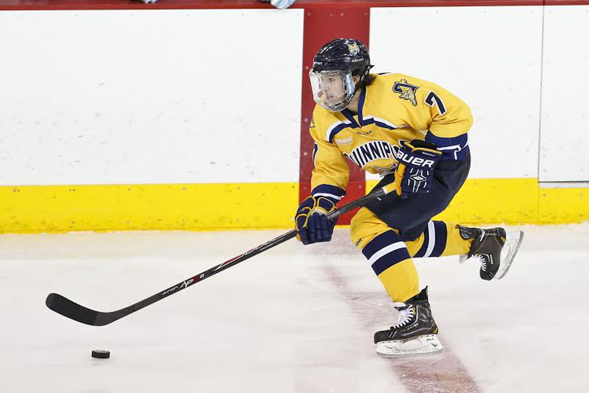 Quinnipiac freshman sam Anas skates the puck up ice against Maine.