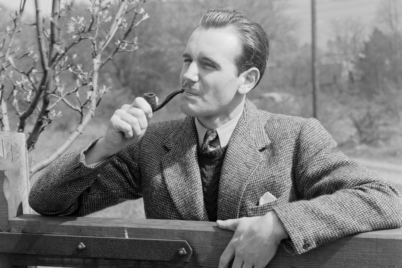 Man at a gate smoking a pipe, 1951.