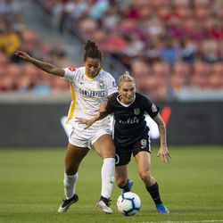 Utah Royals FC defender Gaby Vincent (14) fights with Seattle Reign FC midfielder Jessica Fishlock (10) for control of the ball during their match at Rio Tinto Stadium in Sandy on Friday, June 28, 2019.