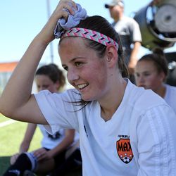 Hannah Christensen squeezes a towel that's been soaking in ice water over her head to keep cool while taking a break from playing soccer during the University of Utah High School Match Camp in Salt Lake City on Monday, June 20, 2016.
