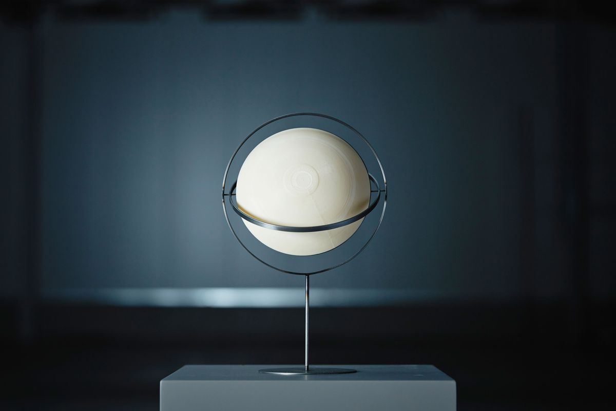 White sphere sitting on metal stand