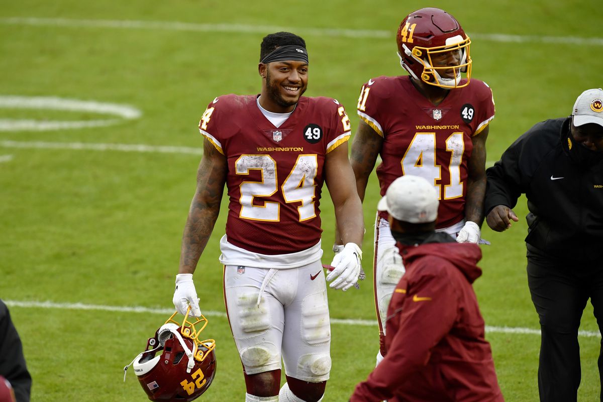 Washington running backs Antonio Gibson (24) and J.D. McKissic (41) walk off the field together smiling after the Dallas Cowboys vs. Washington Football Team NFL game at FedEx Field on October 25, 2020 in Landover, MD.