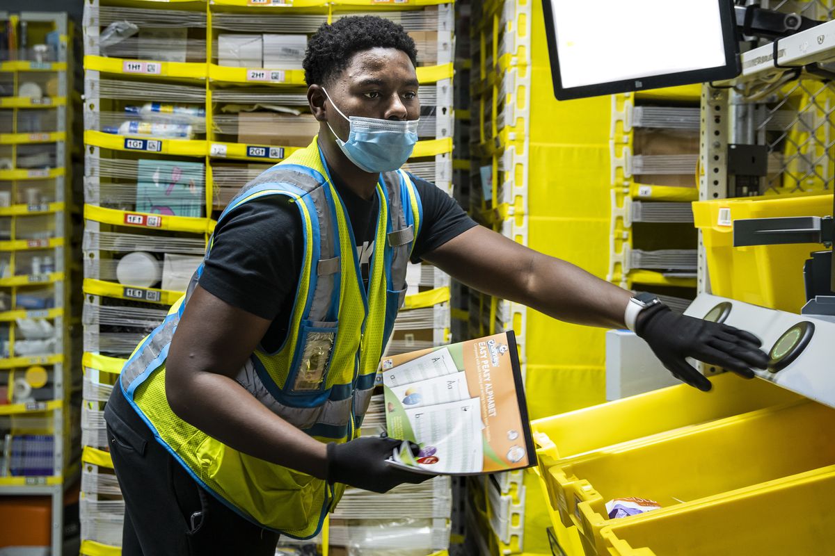 Darnell Gilton, 23, is among about 5,000 employees working at MDW7, the Amazon Robotic Fulfillment Center in Monee.