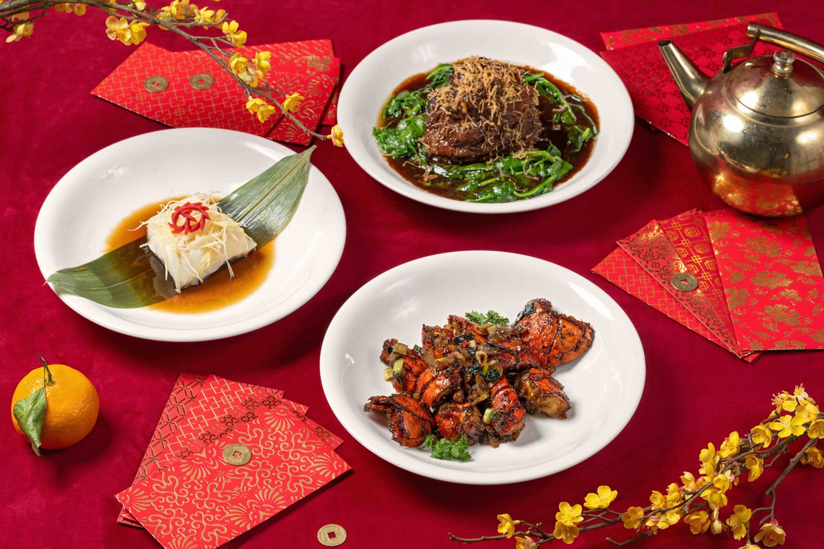 Lunar New Year Chinese dishes with red envelopes and golden teapot.