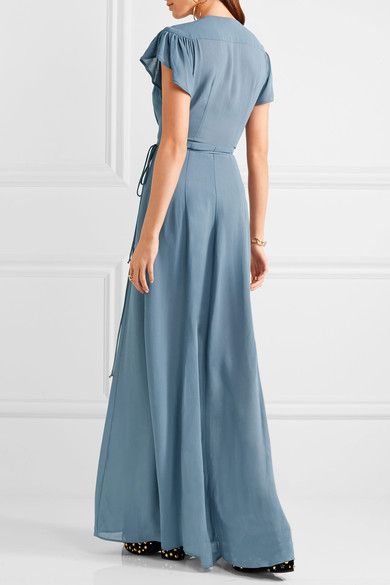 Model in blue plunging neckline dress.