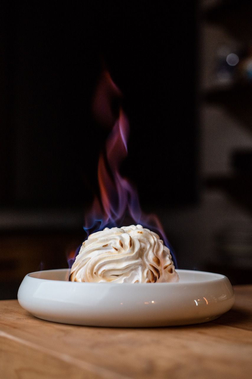 Flaming meringue dessert in a bowl.
