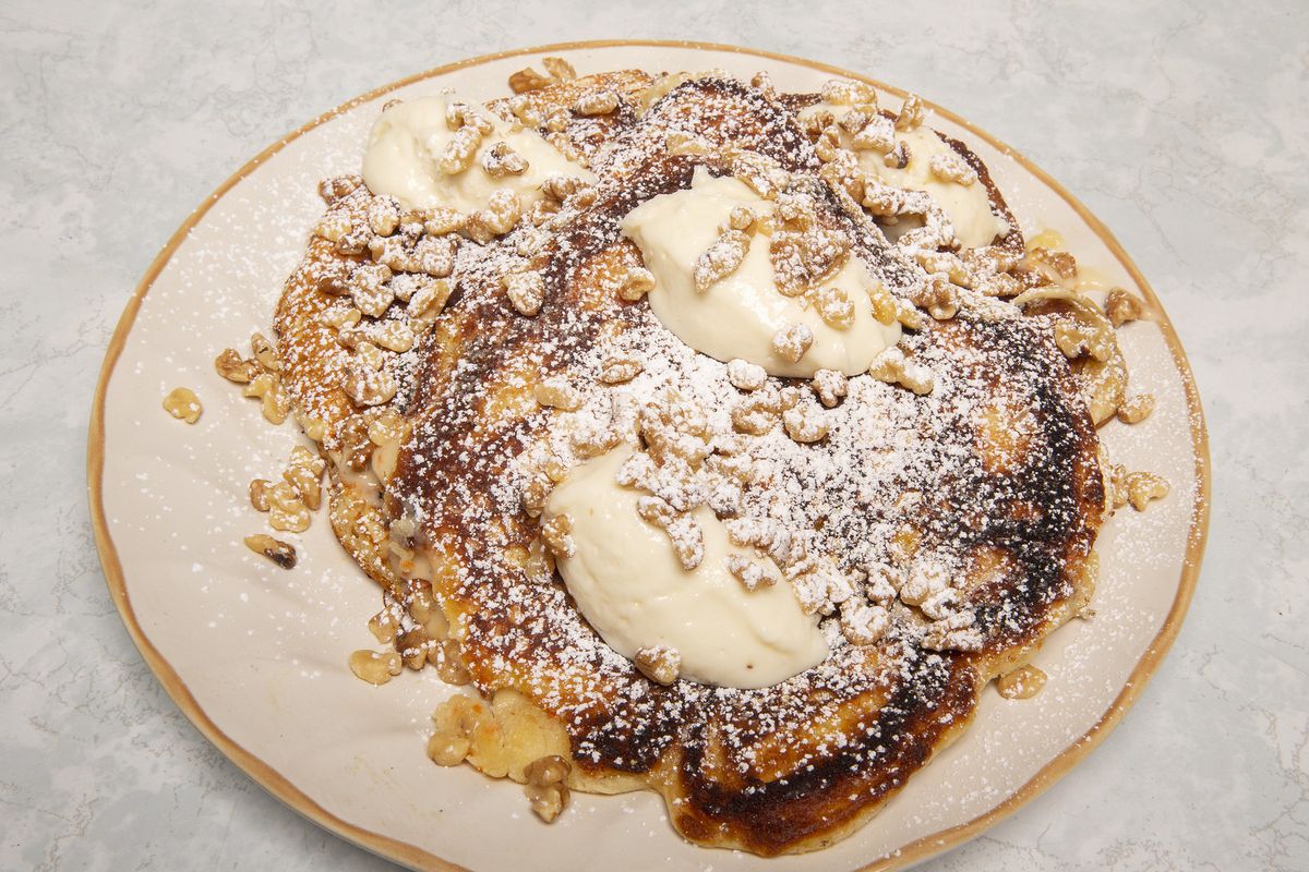 Pancakes coffered with walnuts, butter, powdered sugar.