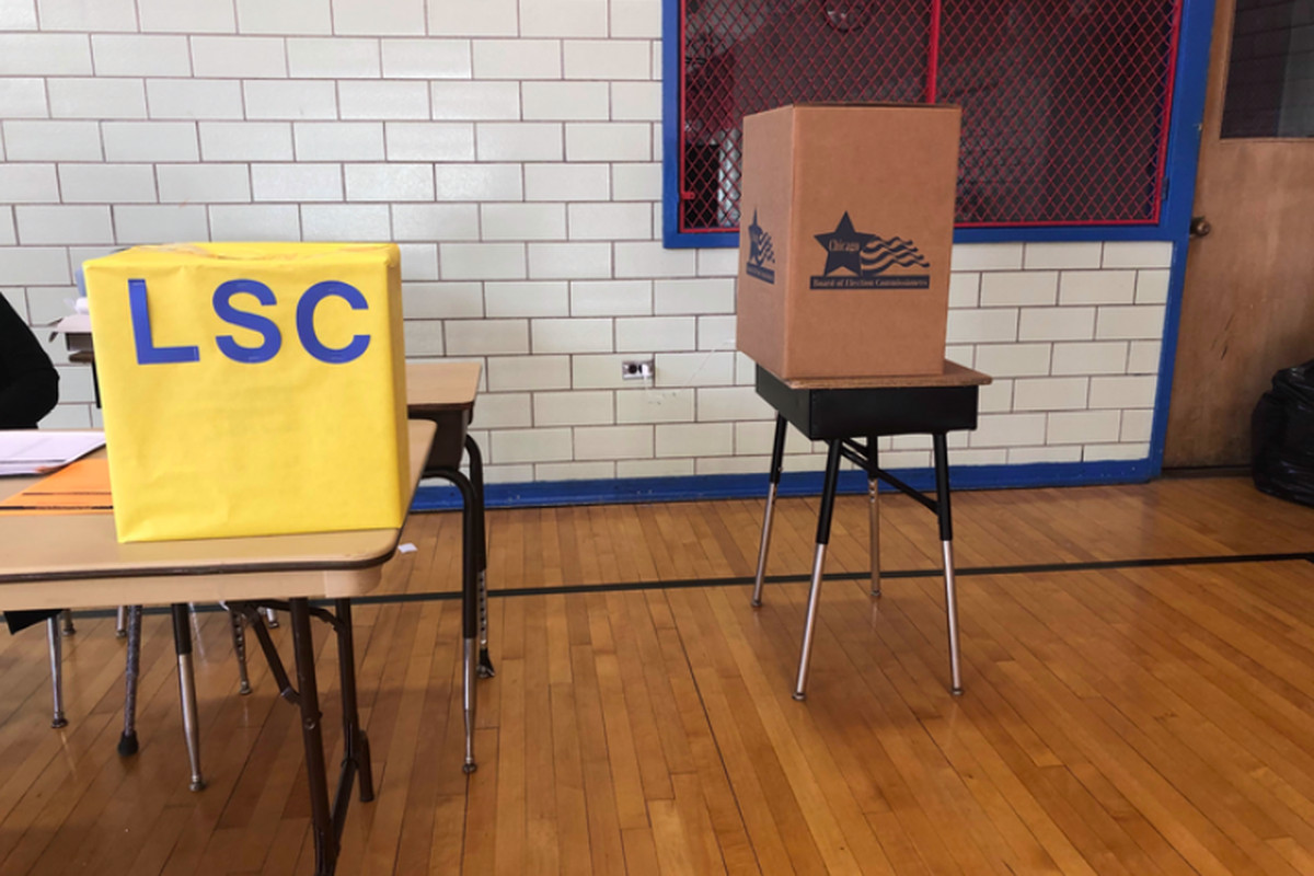 Two boxes for ballots at Yates Elementary in Chicago: The yellow box is for mail-in ballots dropped off at the campus and the brown box is for votes cast on site. 