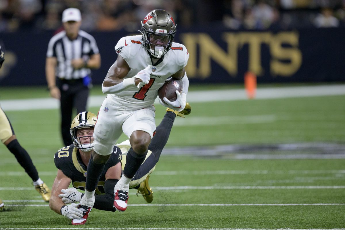 Tampa Bay Buccaneers running back Rachaad White (1) breaks away from a tackle attempt by New Orleans Saints linebacker Pete Werner (20) during the first quarter at the Caesars Superdome.