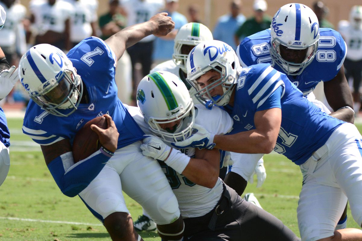 Duke Blue Devils quarterback Anthony Boone (7) is tackled by Tulane Green Wave safety Sam Scofield (35) during the first half at Wallace Wade Stadium.
