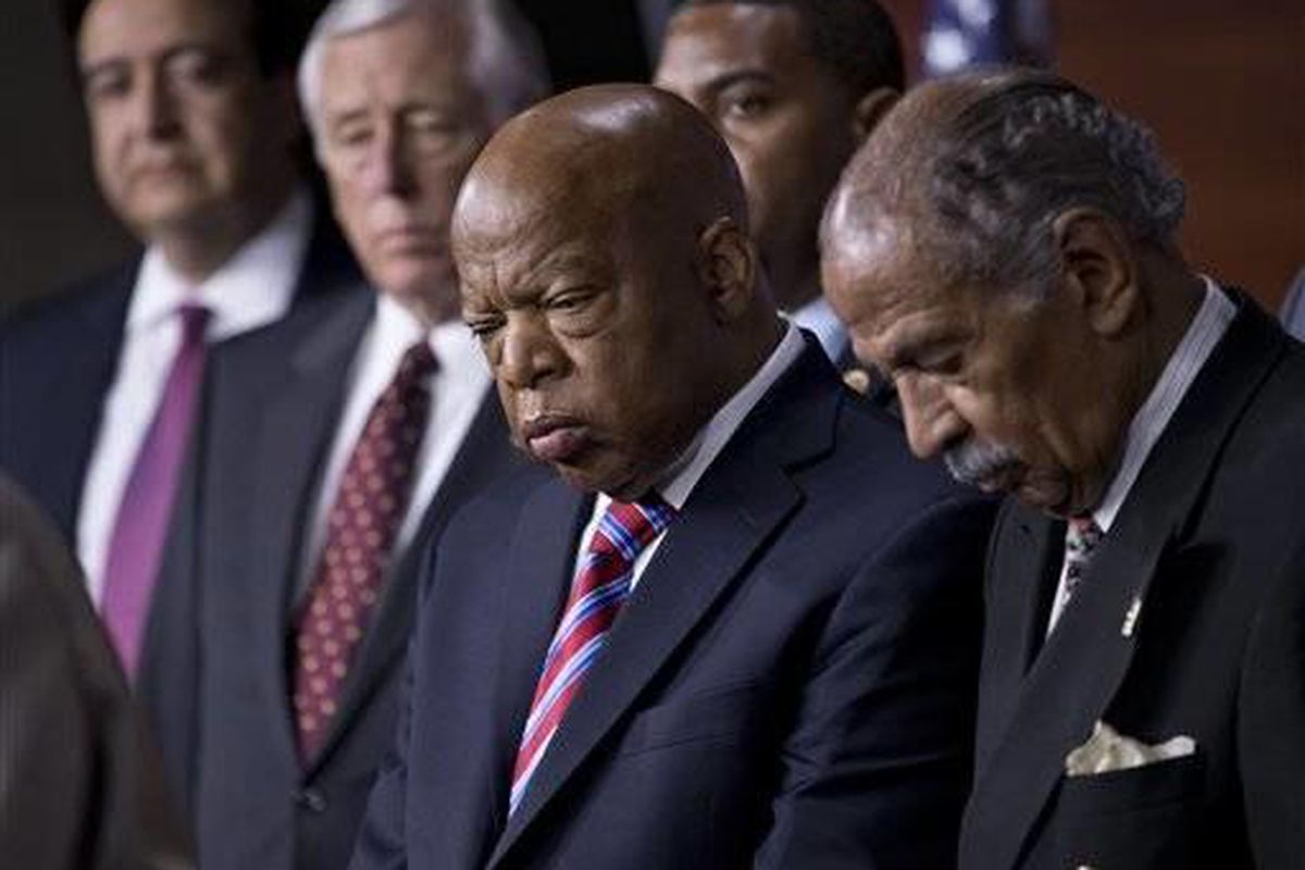 Rep. John Lewis, D-Ga., center, and Rep. John Conyers, D-Mich., right, co-chairs of the Civil Rights Taskforce of the Congressional Black Caucus, join other members of the House to express disappointment in the Supreme Court's decision on Shelby County v.