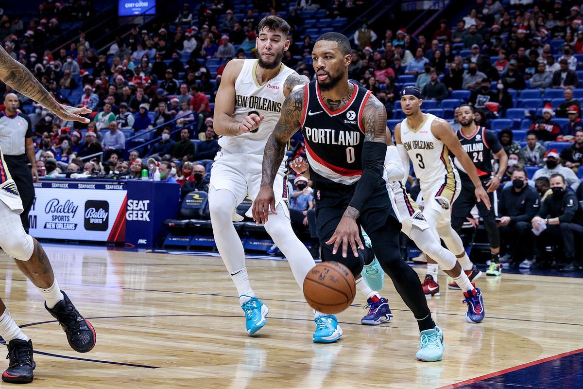 Portland Trail Blazers guard Damian Lillard (0) dribbles against New Orleans Pelicans center Willy Hernangomez (9) during the first half at Smoothie King Center.