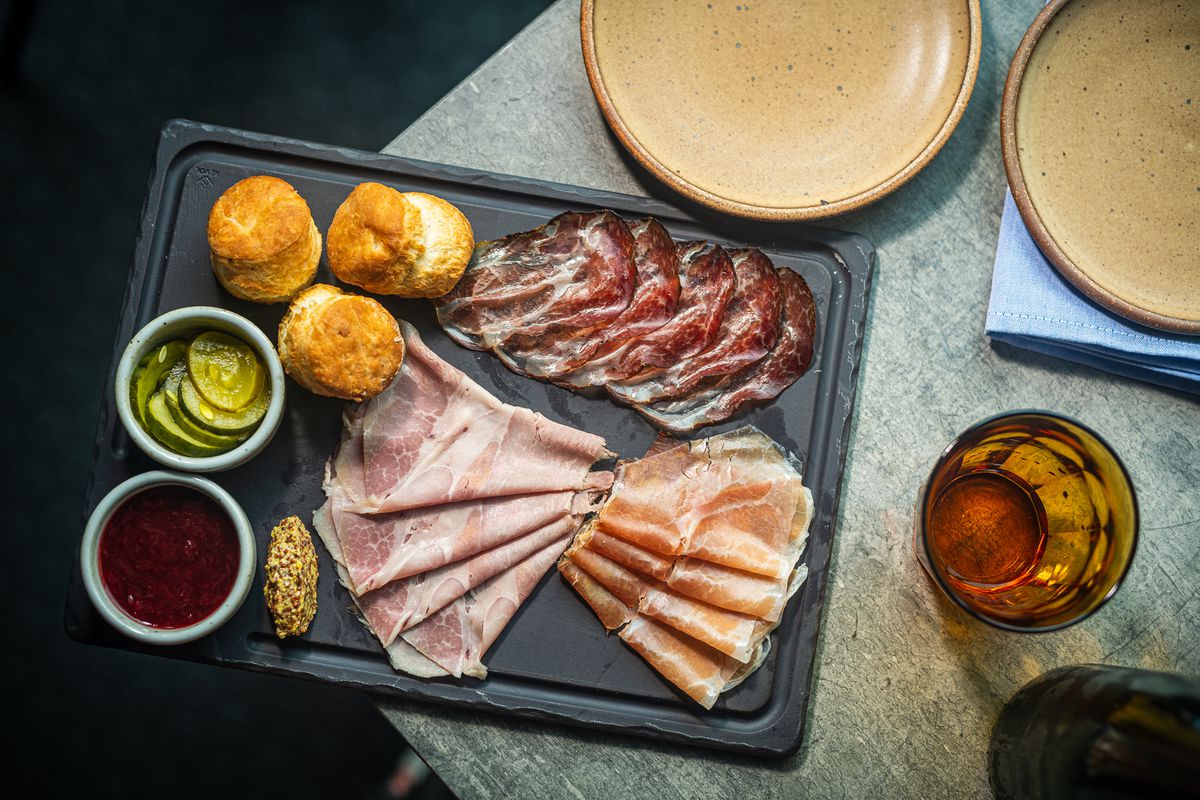 A charcuterie “salthouse board” at No Goodbyes comes with black pepper biscuits, homemade pickles, and jam.