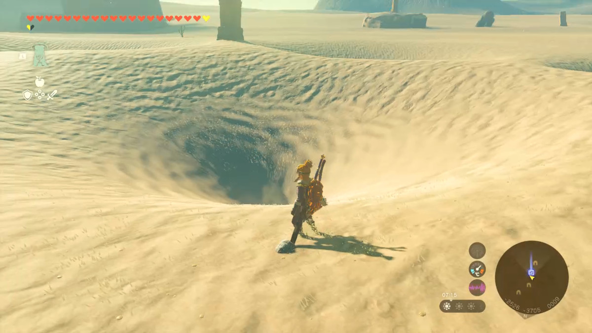 Link stands by a vortex in the sand in Zelda Tears of the Kingdom.