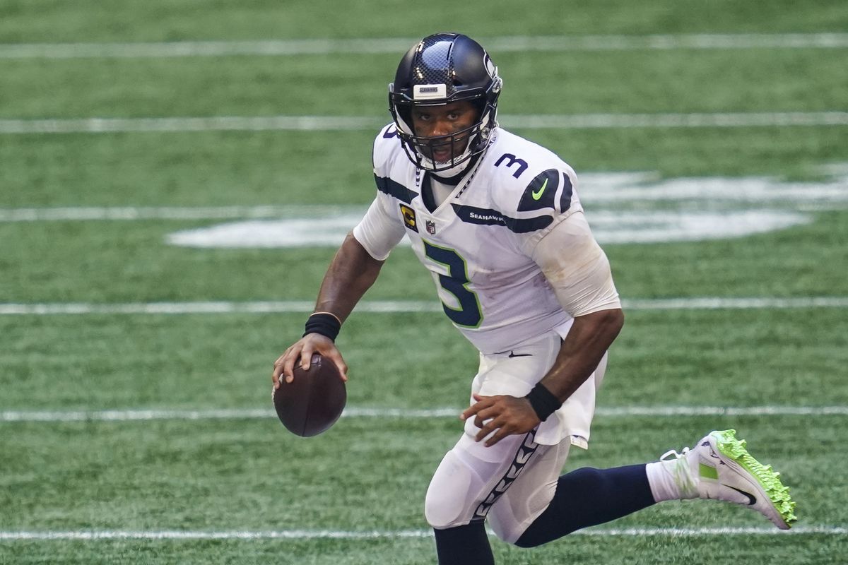 Seattle Seahawks quarterback Russell Wilson runs with the ball against the Atlanta Falcons during the second half at Mercedes-Benz Stadium.