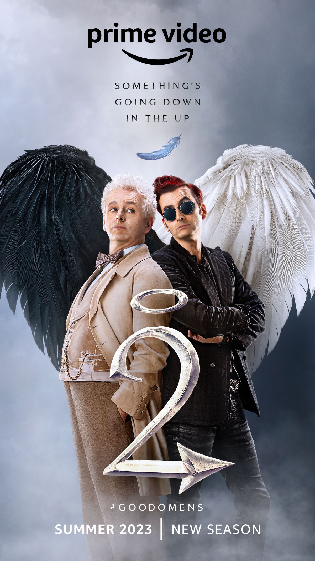an angel and a demon standing back to back, their wings forming a heart, with a big 2 and a halo over it in front of them, in the poster for the second season of Good Omens