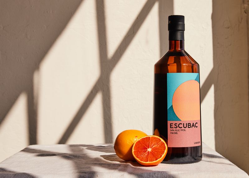 A bottle of Escubac botanical spirit with oranges 