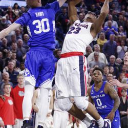 Gonzaga guard Zach Norvell Jr. (23) shoots next to BYU guard TJ Haws (30) during the second half of an NCAA college basketball game in Spokane, Wash., Saturday, Feb. 3, 2018. Gonzaga won 68-60. (AP Photo/Young Kwak)