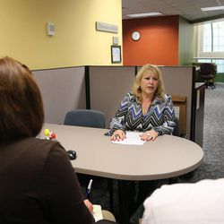 Joan DeLuca, center, talks with Reese Cooper and Heather Mousley in a mock interview to help her get a job through the Department of Workforce Services Tuesday, Nov. 19, 2013, in Salt Lake City.