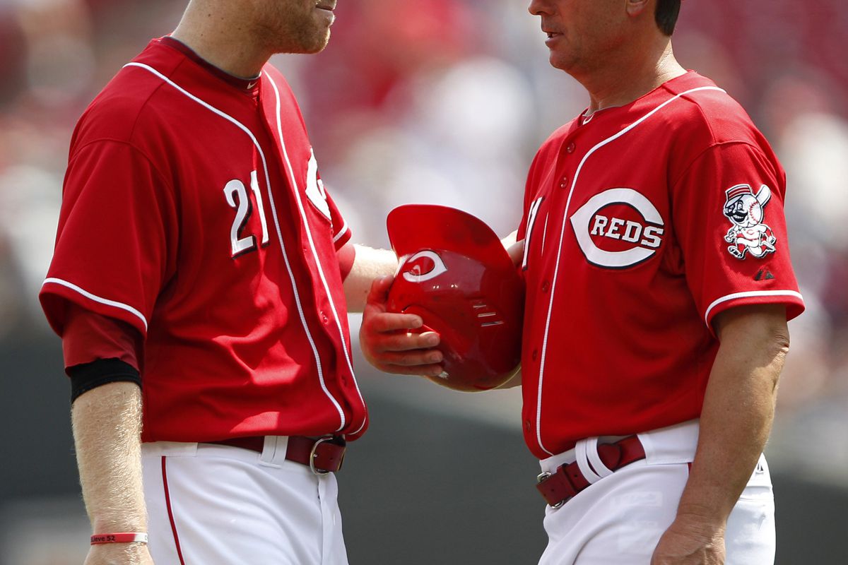 Cincinnati Reds third baseman Todd Frazier (21) talks to third base coach Mark Berry (41). WHAT ARE THEY SAYING? WHAT DOES IT ALL MEAN?