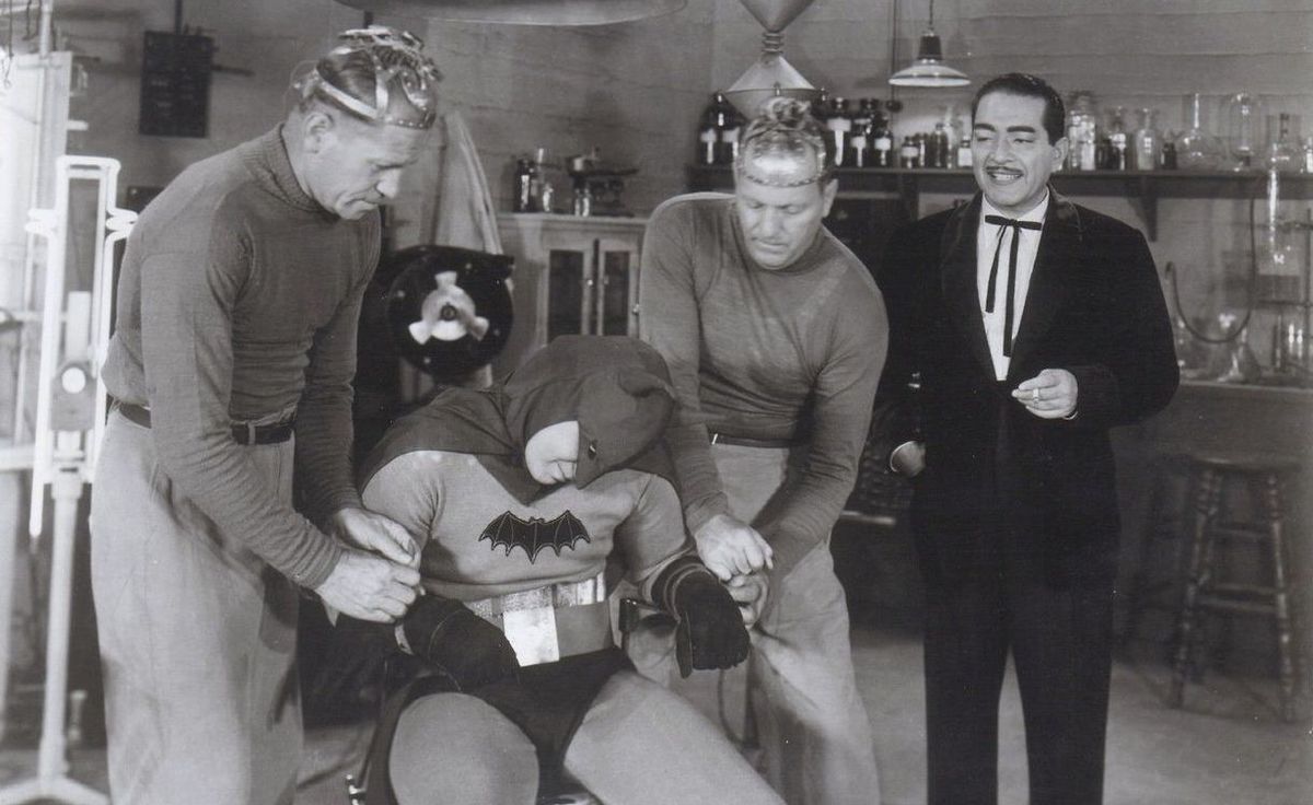 Daka’s mind-controlled minions tie Batman to a chair in the 1943 Batman serial