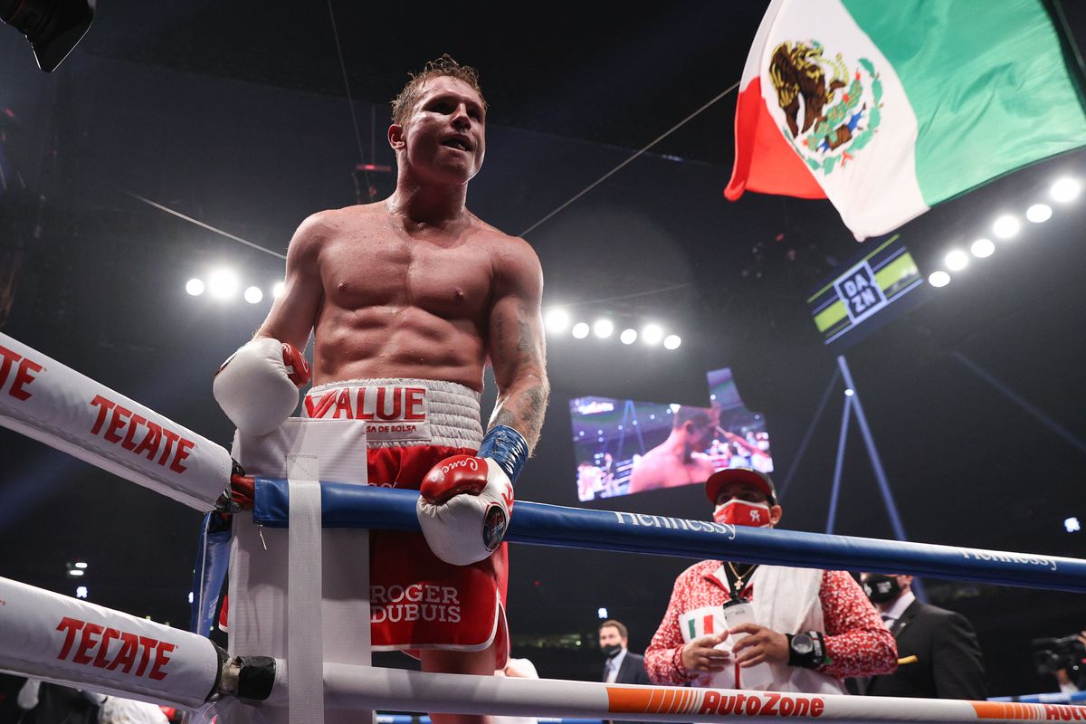 Canelo Alvarez (red trunks) celebrates after defeating Callum Smith (white trunks) during their WBA, WBC and Ring Magazine super middleweight championship bout at the Alamodome in San Antonio, TX.