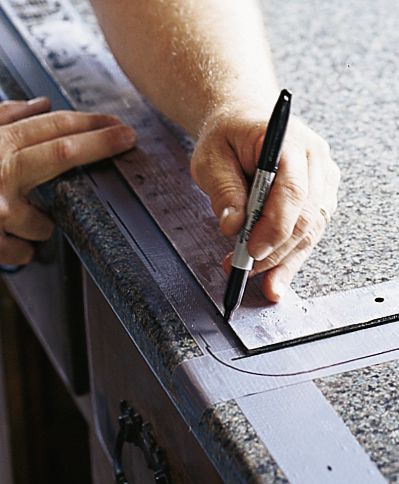 Ruler and marked edges on a kitchen counter. 
