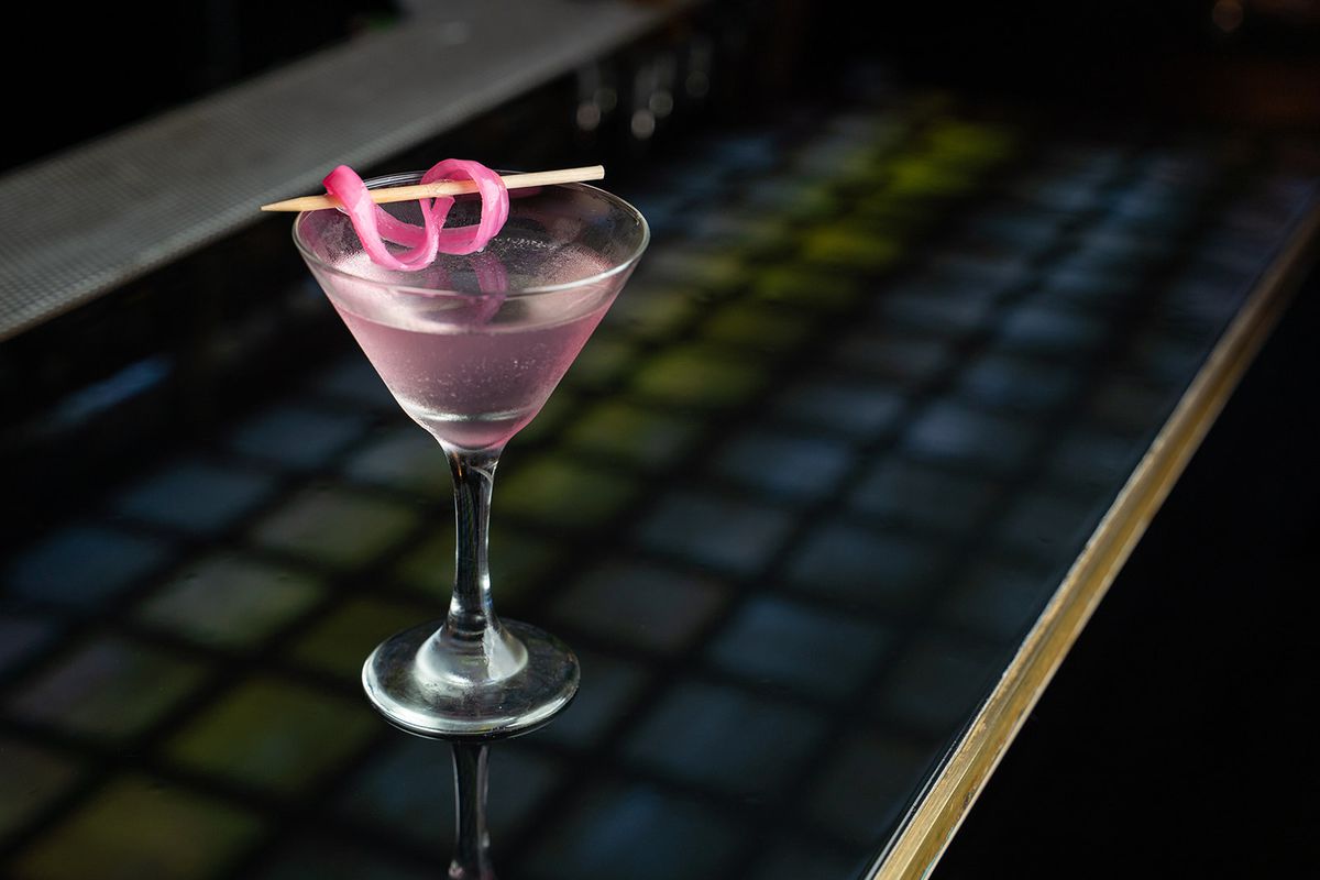 A martini garnished with pickled onion.