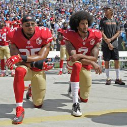 San Francisco's Colin Kaepernick (7) and Eric Reid (35) kneel during the national anthem before an NFL football game against the Carolina Panthers in Charlotte, North Carolina, Sunday, Sept. 18, 2016.