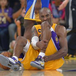 Los Angeles Lakers guard Kobe Bryant grimaces after being injured during the second half of their NBA basketball game against the Golden State Warriors, Friday, April 12, 2013, in Los Angeles. The Lakers won 118-116. 