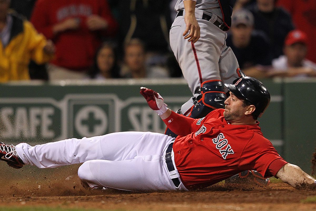 BOSTON, MA - JUNE 8: Nick Punto #5 of the Boston Red Sox beats the throw to the plate to score against the Washington Nationals in the ninth inning at Fenway Park June 8, 2012  in Boston, Massachusetts.  (Photo by Jim Rogash/Getty Images)