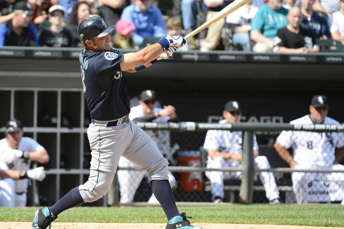 The official caption for this photo reads "Seattle Mariners second baseman Dustin Ackley (13) gets a hit against the Chicago White Sox during the third inning at US Cellular Field."
