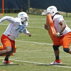 DAVIE, FL - MAY 23: Ja'Wuan James #72 and Billy Turner #77 of the Miami Dolphins participate in drills during the rookie minicamp on May 23, 2014 at the Miami Dolphins training facility in Davie, Florida. 