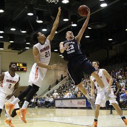 BYU's Skyler Halford shoots under pressure by Pepperdine's Shawn Olden during the first half of an NCAA college basketball game Thursday, Feb. 5, 2015, in Malibu, Calif.
