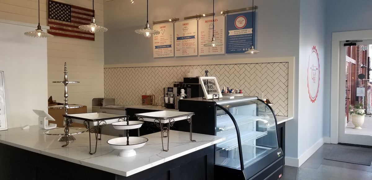 An interior shot of the counter and menu display inside Crave Pie at Alpharetta City Center