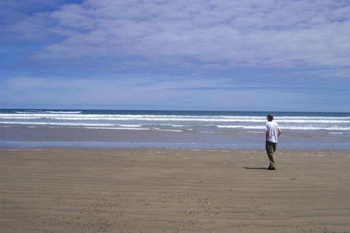 A picture taken by my father of me on a beach in New Zealand.