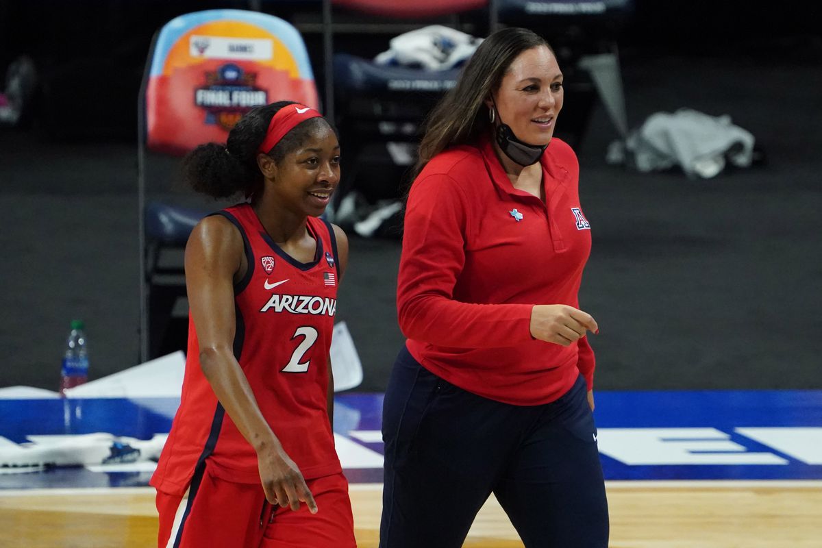 Arizona Wildcats guard Aari McDonald and Arizona Wildcats head coach Adia Barnes walk off the court after defeating the UConn Huskies in the national semifinals of the women’s Final Four of the 2021 NCAA Tournament at Alamodome.