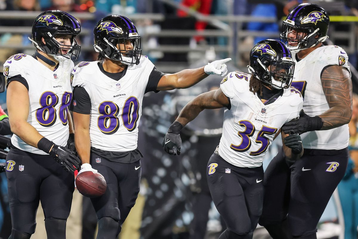 Isaiah Likely #80 (2L) of the Baltimore Ravens celebrates his touchdown with Charlie Kolar #88 and Gus Edwards #35 during the first half of the game against the Jacksonville Jaguars at EverBank Field on December 17, 2023 in Jacksonville, Florida.