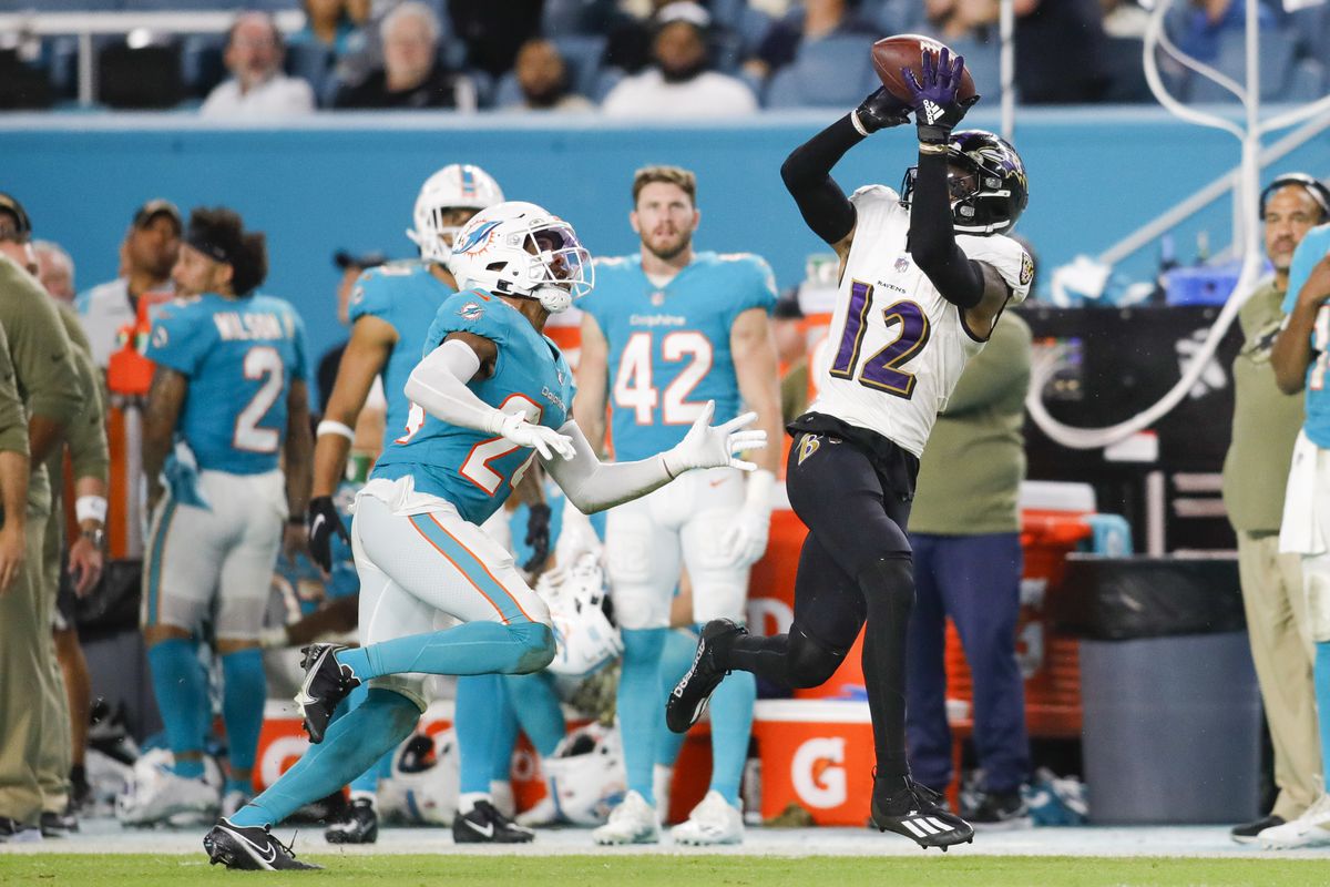 Baltimore Ravens wide receiver Rashod Bateman (12) catches the football against Miami Dolphins cornerback Byron Jones (24) during gate fourth quarter at Hard Rock Stadium.