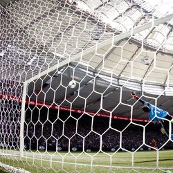 Vancouver goalkeeper Joe Cannon dives in vain as a shot by Real Salt Lake's Olmes Garcia finds the back of the net.  