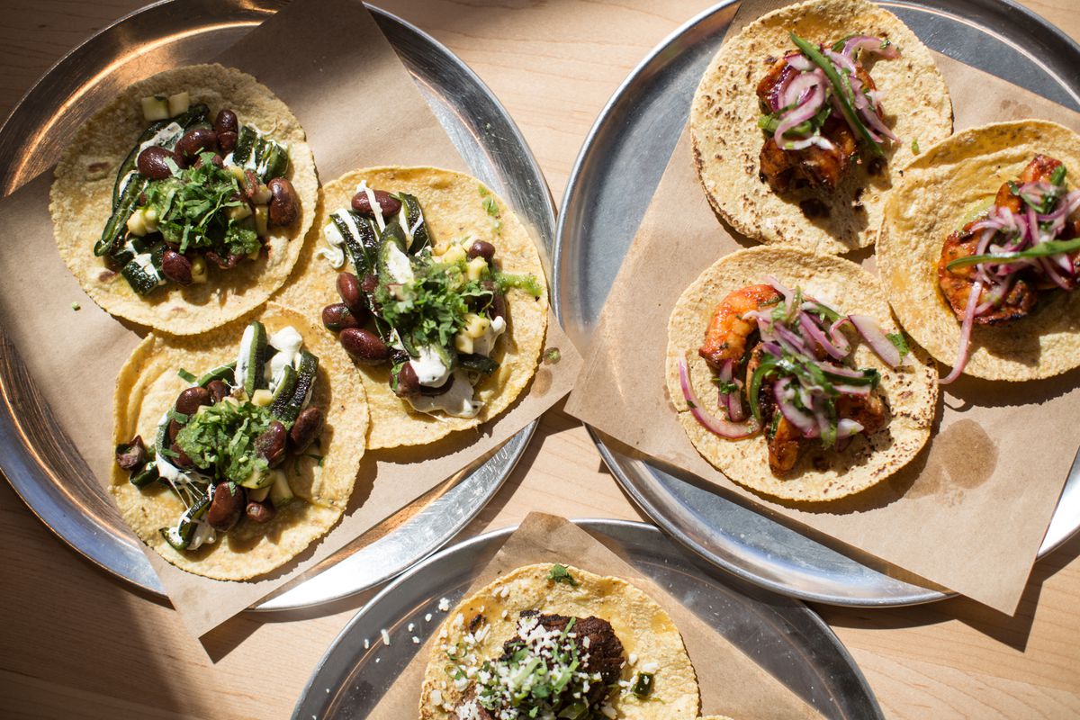 three round trays with tacos