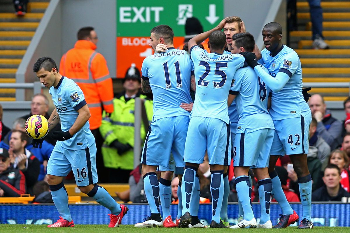 Edin Dzeko (3rd R) of Manchester City is congratulated by teammates after scoring a goal to level the scores at 1-1 during the Barclays Premier League match between Liverpool and Manchester City at Anfield on March 1, 2015 in Liverpool, England.