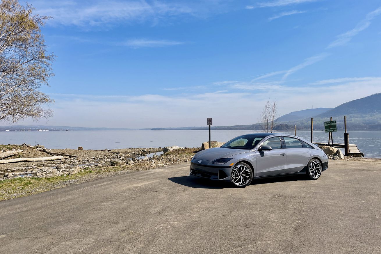 A Hyundai Ioniq 6 parked in front of a body of water