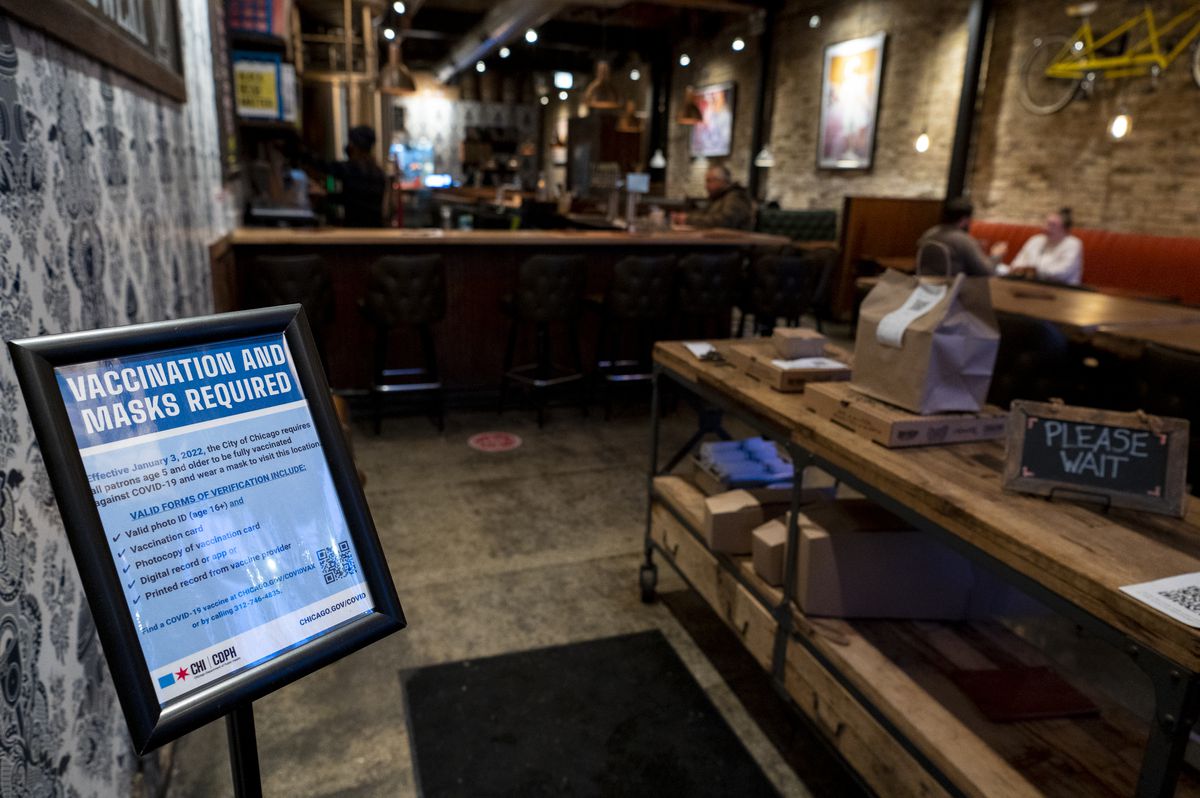 A sign from the Chicago Department of Public Health, displayed near the entrance of Corridor Brewery &amp; Provisions, 3446 N. Southport Ave., alerts customers that masks and proof of vaccination are required to dine indoors.