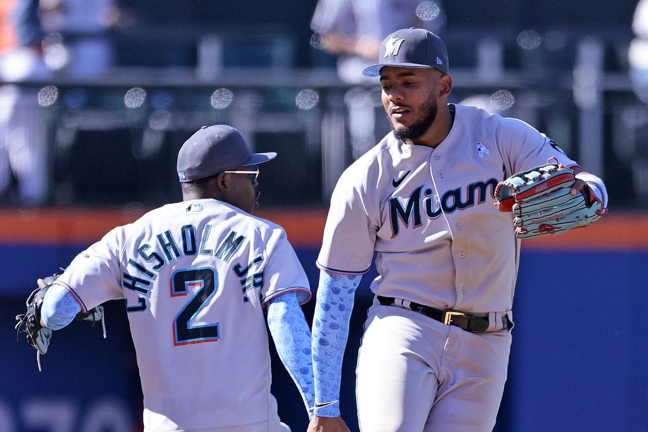 Jerar Encarnacion #64 and Jazz Chisholm Jr. #2 of the Miami Marlins celebrate defeating the New York Mets 6-2 at Citi Field on June 19, 2022 in New York City.