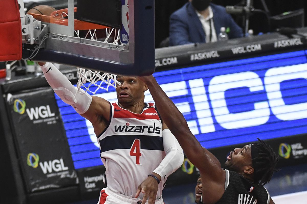 Washington Wizards guard Russell Westbrook (4) beasts Sacramento Kings guard Buddy Hield (24) as he goes up for two during the first quarter of the game between the Washington Wizards and the Sacramento Kings on Wednesday, March 16, 2021.